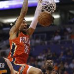 New Orleans Pelicans forward Christian Wood (35) dunks over Phoenix Suns forward Josh Jackson (20) during the first half of an NBA basketball game, Friday, April 5, 2019, in Phoenix. (AP Photo/Rick Scuteri)