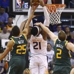Utah Jazz forward Joe Ingles (2) and guard Raul Neto (25) defend against Phoenix Suns forward Richaun Holmes (21) on his shot attempt during the second half of an NBA basketball Wednesday, April 3, 2019, in Phoenix. The Jazz won 118-97. (AP Photo/Ross D. Franklin)