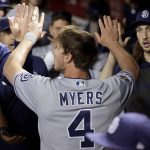 San Diego Padres Wil Myers (4) high-fives teammates after scoring against the Arizona Diamondbacks during the seventh inning of a baseball game Friday, April 12, 2019, in Phoenix. (AP Photo/Matt York)