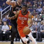 New Orleans Pelicans guard Ian Clark (2) drives past Phoenix Suns forward Dragan Bender during the first half of an NBA basketball game Friday, April 5, 2019, in Phoenix. (AP Photo/Rick Scuteri)