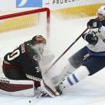 Winnipeg Jets right wing Blake Wheeler, right, gives Arizona Coyotes goaltender Calvin Pickard (30) a face full of ice spray during the first period of an NHL hockey game Saturday, April 6, 2019, in Glendale, Ariz. (AP Photo/Ross D. Franklin)