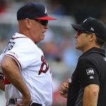 Atlanta Braves manager Brian Snitker challenges a call with first base umpire Stu Scheurwater on a double by Arizona Diamondbacks Wilmer Flores that stood after review during the third inning of a baseball game, Thursday, April 19, 2019, in Atlanta. ( Curtis Compton/Atlanta Journal-Constitution via AP)