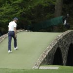 Tiger Woods crosses the Hogan Bridge during the second round for the Masters golf tournament Friday, April 12, 2019, in Augusta, Ga. (AP Photo/Chris Carlson)