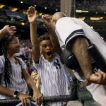 New York Yankees starting pitcher C.C. Sabathia greets his children after throwing his 3,000th career strikeout, during the second inning of a baseball game against the Arizona Diamondbacks on Tuesday, April 30, 2019, in Phoenix. (AP Photo/Matt York)