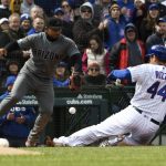 Chicago Cubs' Anthony Rizzo (44) slides safely into third base with a one-run triple as Arizona Diamondbacks third baseman Eduardo Escobar takes a late throw during the fourth inning of a baseball game, Friday, April 19, 2019, in Chicago. (AP Photo/David Banks)
