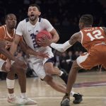 TCU guard Alex Robinson (25) drives to the basket against Texas guard Kerwin Roach II (12) and guard Matt Coleman III during the first half of a semifinal college basketball game in the National Invitational Tournament, Tuesday, April 2, 2019, at Madison Square Garden in New York. (AP Photo/Mary Altaffer)