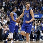 Dallas Mavericks' Devin Harris (34) and Dirk Nowitzki (41) celebrate a basket by Nowitzki during the first half of the team's NBA basketball game against the Phoenix Suns in Dallas, Tuesday, April 9, 2019. (AP Photo/Tony Gutierrez)