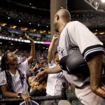 New York Yankees starting pitcher C.C. Sabathia greets his kids after throwing his 3,000th career strikeout, during the second inning of the team's baseball game against the Arizona Diamondbacks, Tuesday, April 30, 2019, in Phoenix. (AP Photo/Matt York)