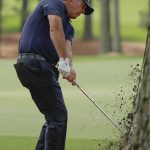 Phil Mickelson hits from behind a tree on the third hole during the second round for the Masters golf tournament Friday, April 12, 2019, in Augusta, Ga. (AP Photo/Charlie Riedel)