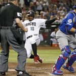 Arizona Diamondbacks' Adam Jones (10) slides home to score on an RBI single by teammate Wilmer Flores as Chicago Cubs catcher Willson Contreras, right, awaits the throw during the fifth inning of a baseball game, Friday, April 26, 2019, in Phoenix. (AP Photo/Ralph Freso)