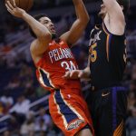 New Orleans Pelicans guard Kenrich Williams (34) drives on Phoenix Suns forward Dragan Bender during the first half of an NBA basketball game Friday, April 5, 2019, in Phoenix. (AP Photo/Rick Scuteri)