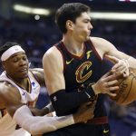 Cleveland Cavaliers forward Cedi Osman, right, has the ball stripped away by Phoenix Suns forward Richaun Holmes, left, during the first half of an NBA basketball game Monday, April 1, 2019, in Phoenix. (AP Photo/Ross D. Franklin)