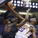 Cleveland Cavaliers guard David Nwaba (12) has his shot blocked by Phoenix Suns forward Josh Jackson (20) during the first half of an NBA basketball game Monday, April 1, 2019, in Phoenix. (AP Photo/Ross D. Franklin)