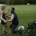 Robert McKnight proposes to Kathryn Sloan on the 12th hole during the second round for the Masters golf tournament Friday, April 12, 2019, in Augusta, Ga. (AP Photo/Chris Carlson)