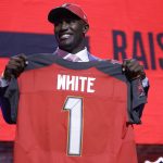 Louisiana State linebacker Devin White poses with his new jersey after the Tampa Bay Buccaneers selected White in the first round at the NFL football draft, Thursday, April 25, 2019, in Nashville, Tenn. (AP Photo/Mark Humphrey)