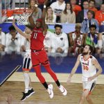 Texas Tech forward Tariq Owens (11) dunks the ball ahead of Virginia's Kyle Guy, left, and Jay Huff, right, during the first half in the championship of the Final Four NCAA college basketball tournament, Monday, April 8, 2019, in Minneapolis. (AP Photo/Matt York)