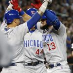 Chicago Cubs' David Bote (13) celebrates with teammates Javier Baez, left, and Anthony Rizzo (44) after hitting a three-run home run against the Arizona Diamondbacks during the third inning of a baseball game, Saturday, April 27, 2019, in Phoenix. (AP Photo/Ralph Freso)