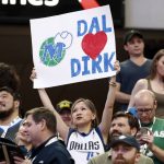 A fan holds up a sign referring to Dallas Mavericks' Dirk Nowitzki during the first half of the team's NBA basketball game against the Phoenix Suns in Dallas, Tuesday, April 9, 2019. (AP Photo/Tony Gutierrez)