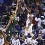 Phoenix Suns guard Troy Daniels, right, shoots over Utah Jazz center Rudy Gobert during the second half of an NBA basketball Wednesday, April 3, 2019, in Phoenix. The Jazz won 118-97. (AP Photo/Ross D. Franklin)