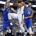 Phoenix Suns guard De'Anthony Melton (14) goes up for a shot as Dallas Mavericks' Dirk Nowitzki (41) and Devin Harris (34) defend during the first half of an NBA basketball game in Dallas, Tuesday, April 9, 2019. (AP Photo/Tony Gutierrez)