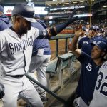 San Diego Padres' Fernando Tatis Jr., left, celebrates his two-run home run against the Arizona Diamondbacks with San Diego Padres coach Damion Easley (15) during the third inning of a baseball game Saturday, April 13, 2019, in Phoenix. (AP Photo/Ross D. Franklin)