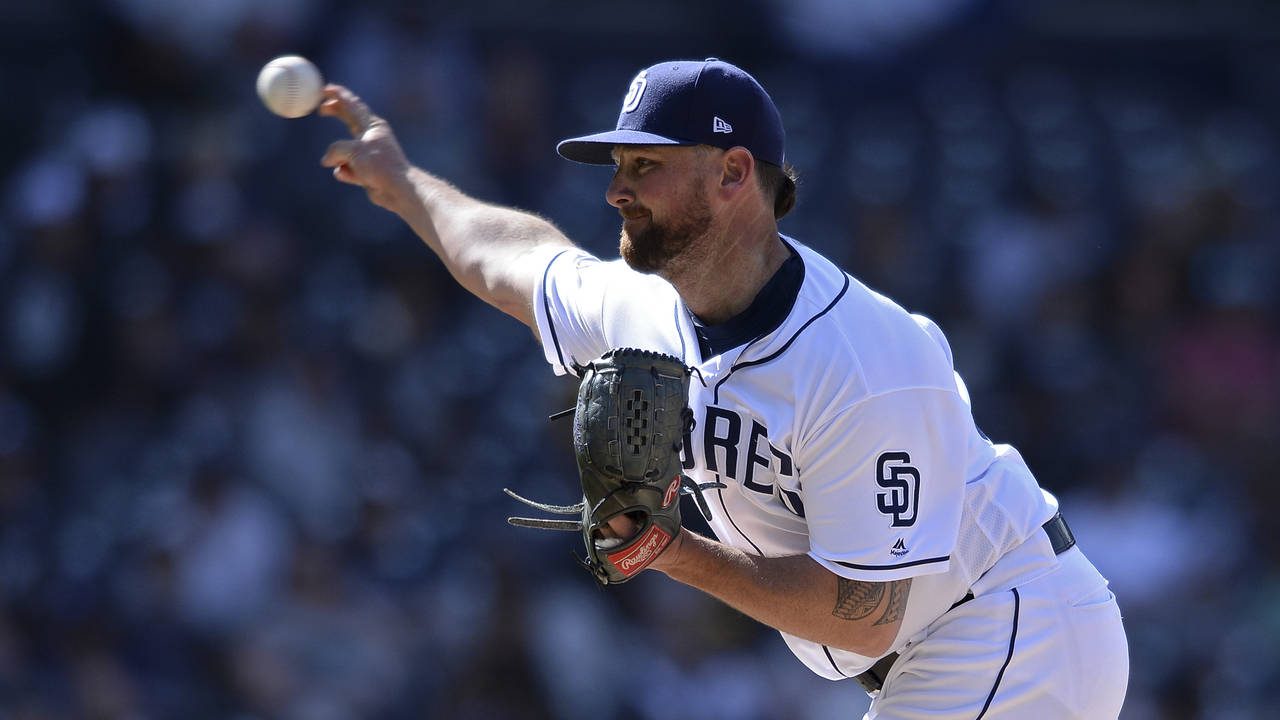 San Diego Padres relief pitcher Kirby Yates works against an Arizona Diamondbacks batter during the...