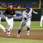 Chicago Cubs' Javier Baez, right, is chased by Arizona Diamondbacks shortstop Nick Ahmed, center, as he gets caught in a run-down during the second inning of a baseball game, Saturday, April 27, 2019, in Phoenix. Baez was out on the play. (AP Photo/Ralph Freso)