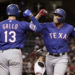 Texas Rangers' Hunter Pence celebrates with Joey Gallo (13) after hitting a solo home run against the Arizona Diamondbacks during the eighth inning of a baseball game Wednesday, April 10, 2019, in Phoenix. (AP Photo/Matt York)