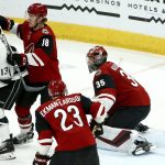 Los Angeles Kings left wing Kyle Clifford (13) redirects the puck past Arizona Coyotes goaltender Darcy Kuemper (35), Coyotes center Christian Dvorak (18) and defenseman Oliver Ekman-Larsson (23) for a goal during the second period of an NHL hockey game Tuesday, April 2, 2019, in Glendale, Ariz. (AP Photo/Ross D. Franklin)