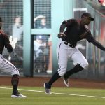 Arizona Diamondbacks right fielder Adam Jones, right, is unable to make a catch on a foul ball hit by San Diego Padres' Hunter Renfroe as first baseman Christian Walker (53) watches during the first inning of a baseball game Saturday, April 13, 2019, in Phoenix. (AP Photo/Ross D. Franklin)