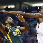 Utah Jazz forward Royce O'Neale (23) tries to get off a shot against Phoenix Suns forward Josh Jackson during the second half of an NBA basketball Wednesday, April 3, 2019, in Phoenix. The Jazz won 118-97. (AP Photo/Ross D. Franklin)