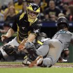 Pittsburgh Pirates catcher Francisco Cervelli, left, can't get the tag on Arizona Diamondbacks' Jarrod Dyson who scores from third on a fielder's choice by David Peralta in the sixth inning of a baseball game in Pittsburgh, Tuesday, April 23, 2019. (AP Photo/Gene J. Puskar)