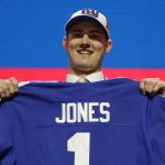 Duke quarterback Daniel Jones poses with his new jersey after the New York Giants selected Jones in the first round at the NFL football draft, Thursday, April 25, 2019, in Nashville, Tenn. (AP Photo/Mark Humphrey)