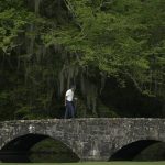 Tiger Woods crosses the Nelson Bridge during the second round for the Masters golf tournament Friday, April 12, 2019, in Augusta, Ga. (AP Photo/Chris Carlson)