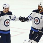 Winnipeg Jets center Mark Scheifele (55) celebrates his goal against the Arizona Coyotes with defenseman Dustin Byfuglien (33) during the first period of an NHL hockey game Saturday, April 6, 2019, in Glendale, Ariz. (AP Photo/Ross D. Franklin)