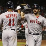 Boston Red Sox's Mitch Moreland celebrates with Rafael Devers (11) after hitting a solo home run against the Arizona Diamondbacks in the seventh inning of a baseball game, Sunday, April 7, 2019, in Phoenix. (AP Photo/Rick Scuteri)