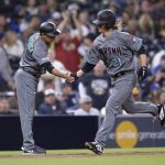 Arizona Diamondbacks' Zack Greinke, right, is congratulated by Tony Perezchica as he rounds third base after hitting a home run during the sixth inning of a baseball game against the San Diego Padres, Tuesday, April 2, 2019, in San Diego. (AP Photo/Orlando Ramirez)