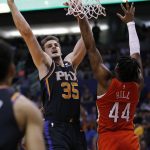 Phoenix Suns forward Dragan Bender (35) shoots over New Orleans Pelicans forward Solomon Hill during the second half of an NBA basketball game Friday, April 5, 2019, in Phoenix. The Suns won 133-126 in overtime. (AP Photo/Rick Scuteri)