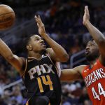 Phoenix Suns guard De'Anthony Melton (14) shoots over New Orleans Pelicans forward Solomon Hill during the second half of an NBA basketball game Friday, April 5, 2019, in Phoenix. The Suns won 133-126 in overtime. (AP Photo/Rick Scuteri)