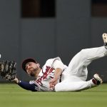 A ball hit for an RBI-single by Arizona Diamondbacks' Nick Ahmed gets away from Atlanta Braves center fielder Ender Inciarte (11) in the fourth inning of a baseball game, Tuesday, April 16, 2019, in Atlanta. (AP Photo/John Bazemore)