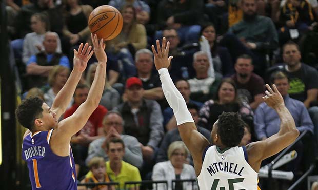 Phoenix Suns guard Devin Booker (1) shoots as Utah Jazz guard Donovan Mitchell (45) defends during ...