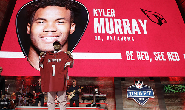 Oklahoma quarterback Kyler Murray shows off his new jersey after the Arizona Cardinals selected Mur...