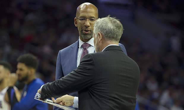 Assistant coach Monty Williams talks to head coach Brett Brown of the Philadelphia 76ers during a t...