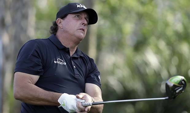 Phil Mickelson watches his tee shot on the 13th hole during the first round of The Players Champion...
