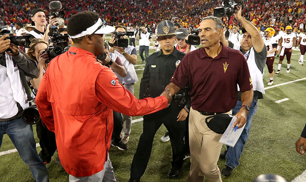 Head coach Herm Edwards of the Arizona State Sun Devils shakes hands with head coach Kevin Sumlin o...