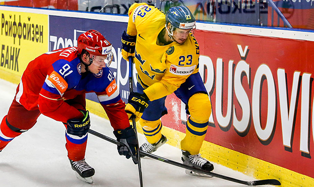 Oliver Ekman-Larsson (R) of Sweden and Vladimir Tarasenko (L) of Russia battle for the puck during ...