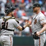 San Francisco Giants pitcher Will Smith, right, is congratulated by catcher Stephen Vogt after pitching the 10th inning to earn a save in the team's victory over the Arizona Diamondbacks in a baseball game, Sunday, May 19, 2019, in Phoenix. (AP Photo/Ralph Freso)
