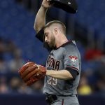 Arizona Diamondbacks starting pitcher Merrill Kelly wipes his forehead as he struggles against the Tampa Bay Rays during the second inning of a baseball game Monday, May 6, 2019, in St. Petersburg, Fla. (AP Photo/Chris O'Meara)