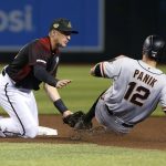 Arizona Diamondbacks shortstop Nick Ahmed, left, tags out San Francisco Giants' Joe Panik on a steal attempt during the fourth inning of a baseball game Saturday, May 18, 2019, in Phoenix. (AP Photo/Ralph Freso)