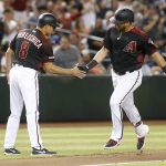 Arizona Diamondbacks' David Peralta, right, is congratulated by third base coach Tony Perezchica after hitting a solo home run against the San Francisco Giants during the fourth inning of a baseball game, Friday, May 17, 2019, in Phoenix. (AP Photo/Ralph Freso)